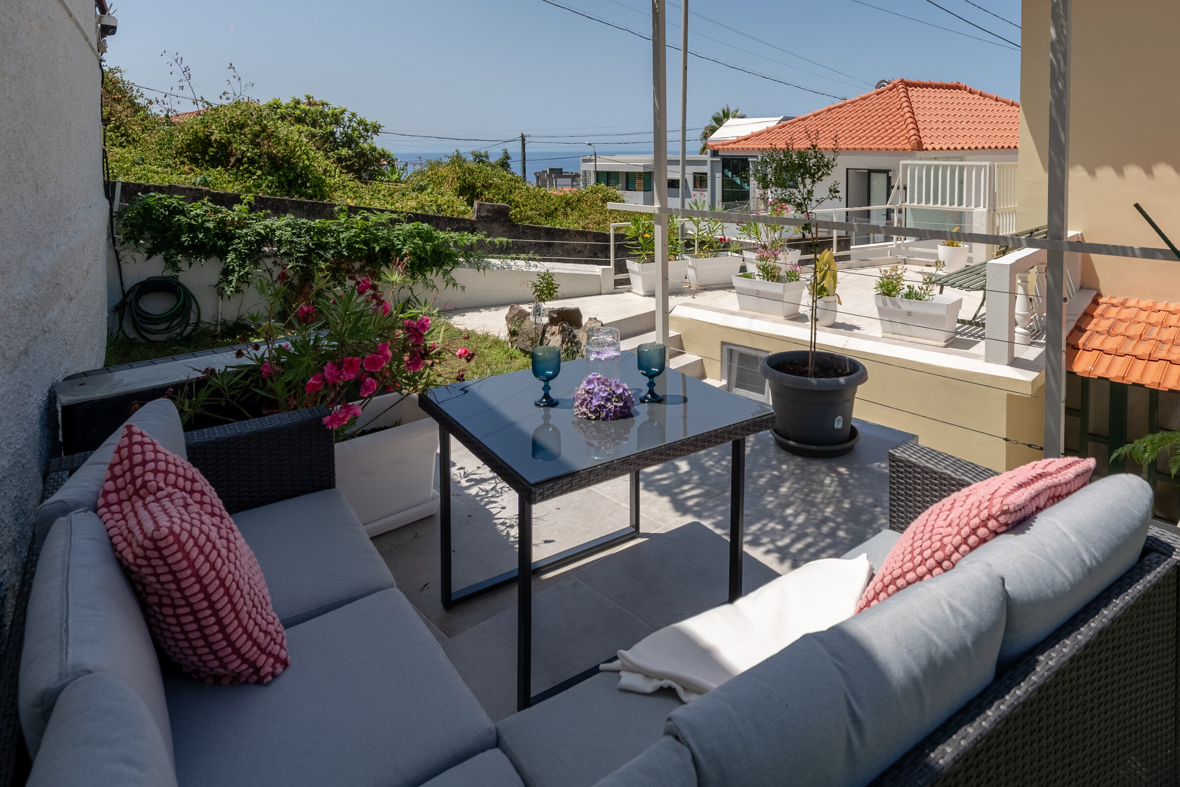 Terrace lounge seating with cushions, overlooking Funchal's rooftops