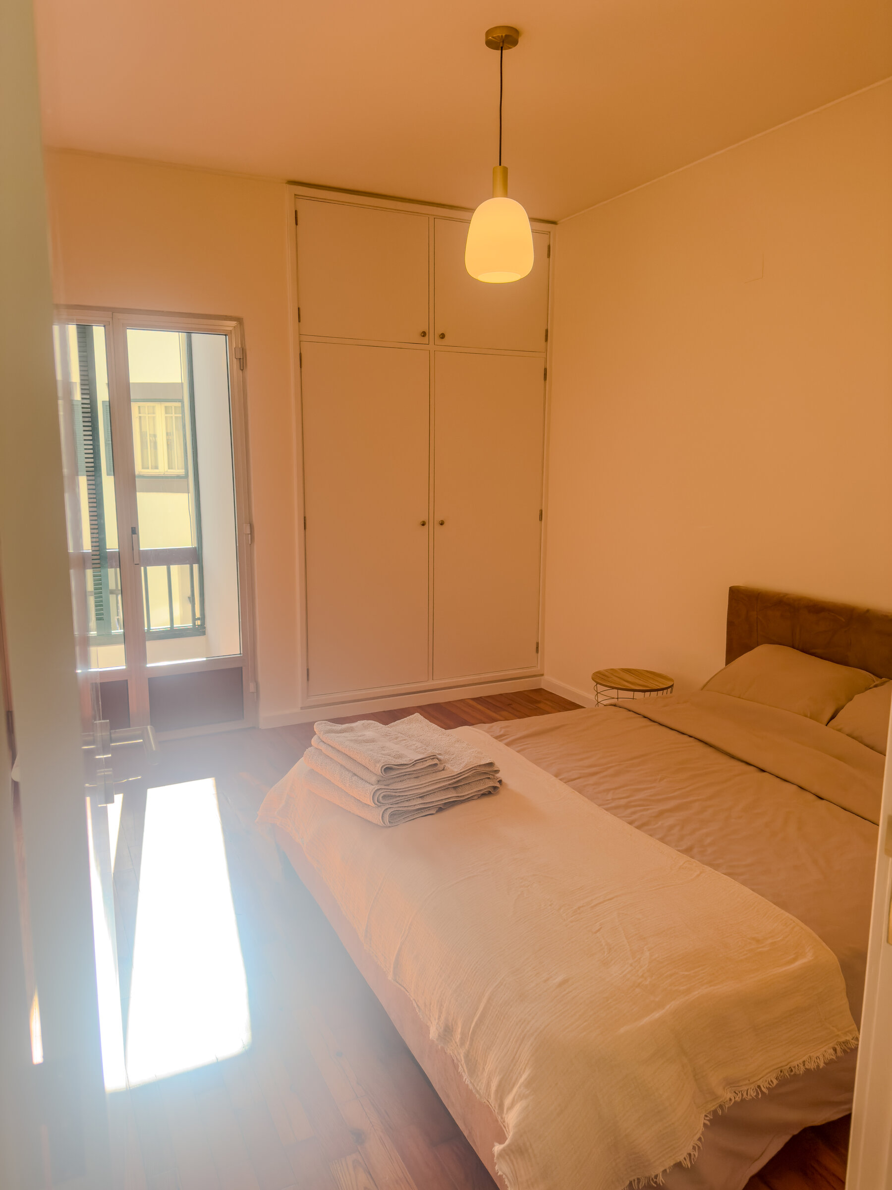 Bright bedroom with wardrobe and natural light