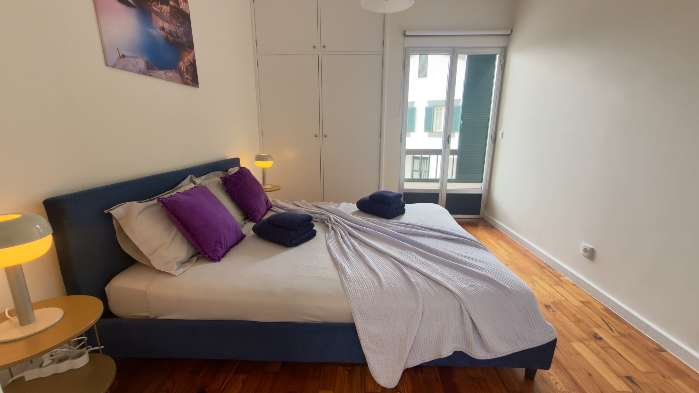 Bedroom with statement navy bed frame and city-art print