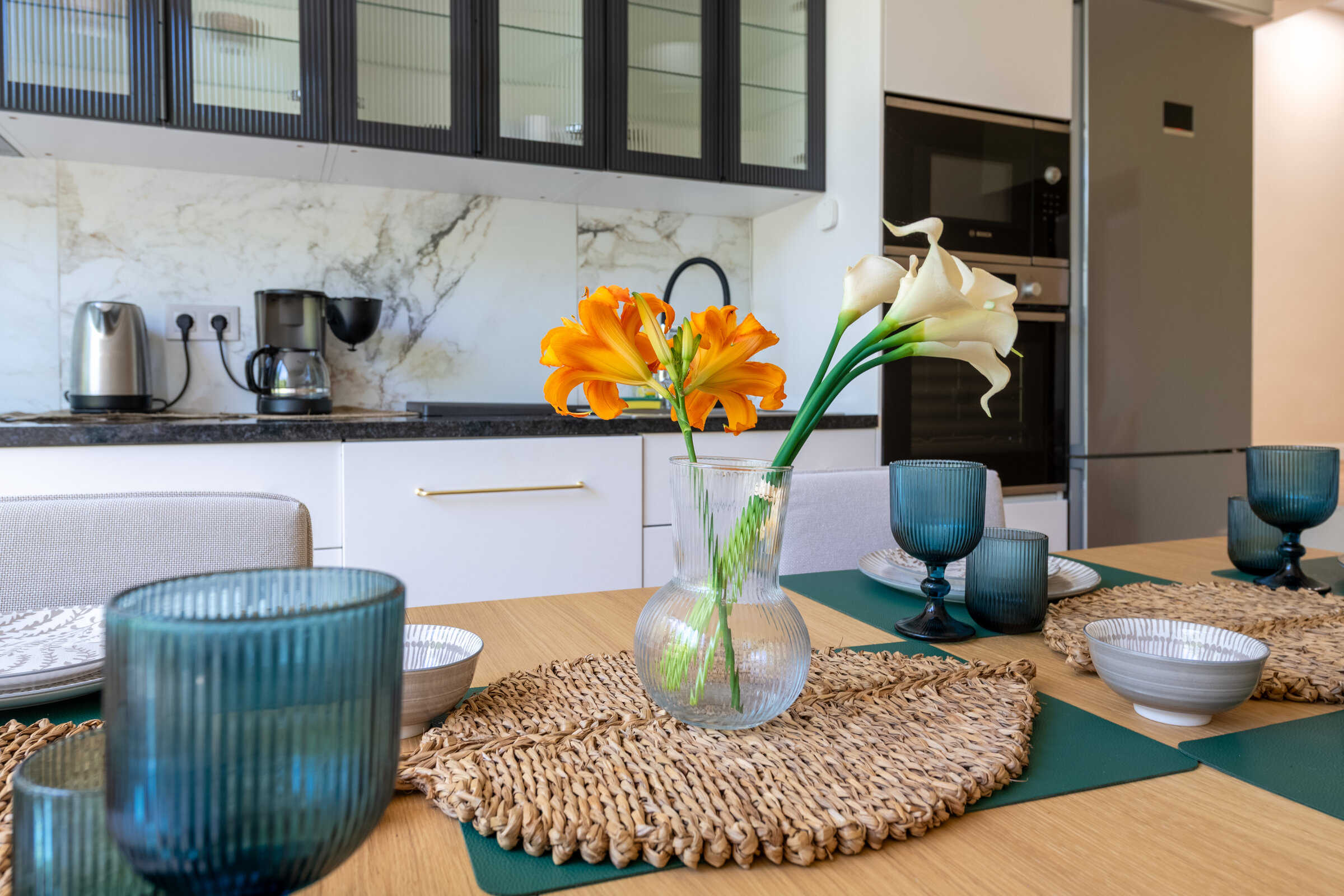 Dining table set with glassware and fresh flowers