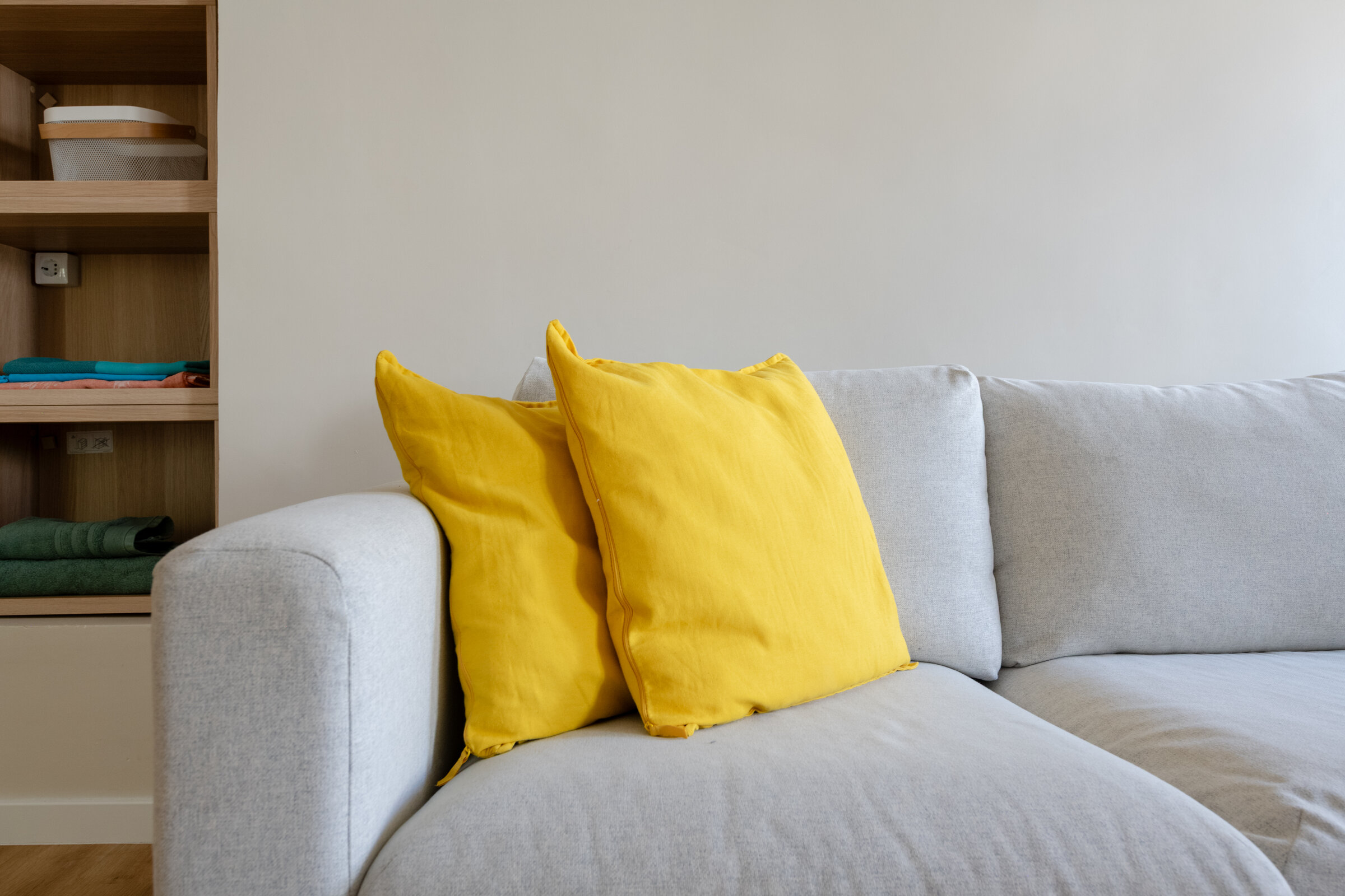 Sofa with yellow cushions, a cosy corner of the living room