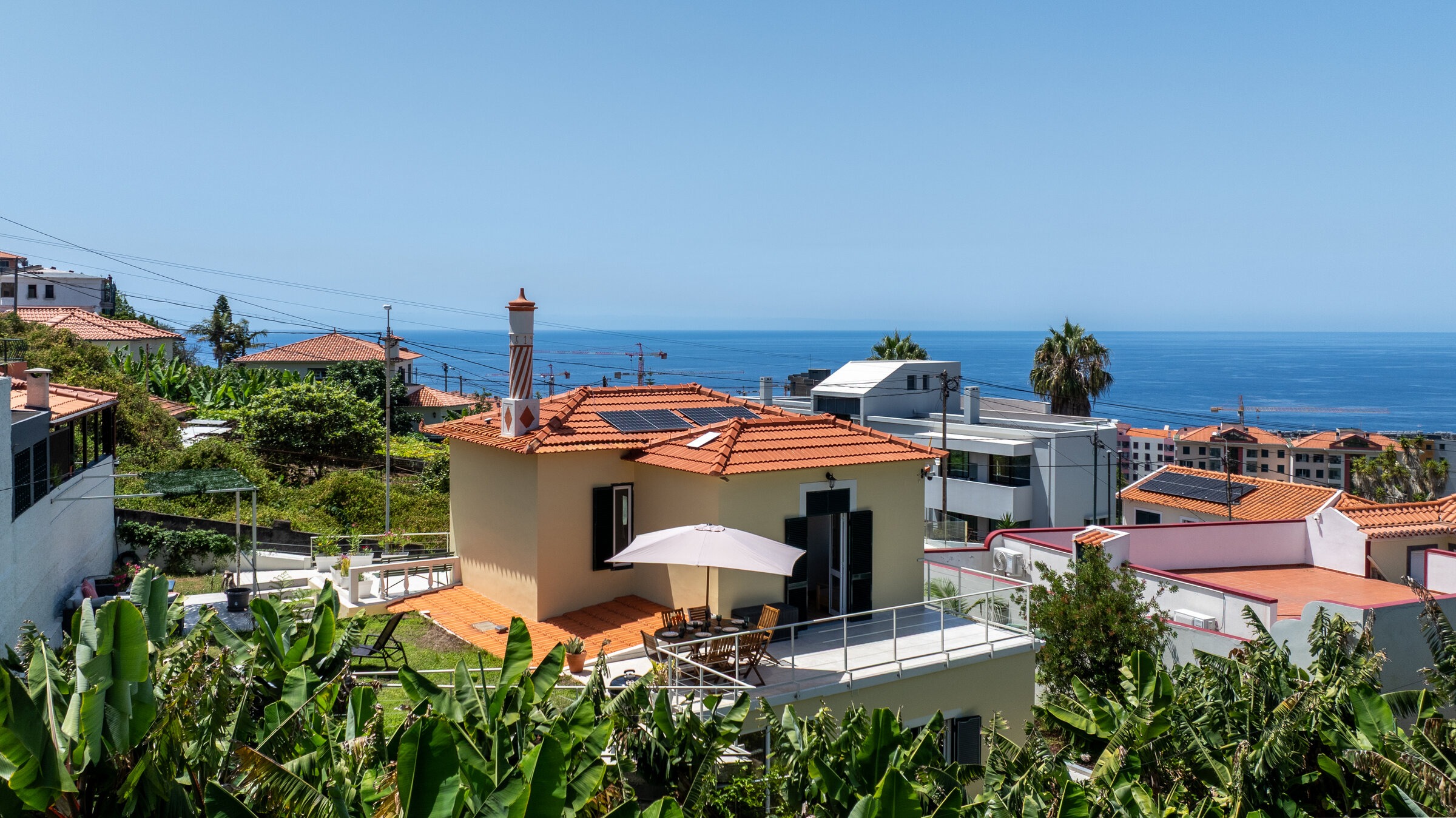 Aerial view of the 1925 villa in São Martinho with the Atlantic Ocean beyond