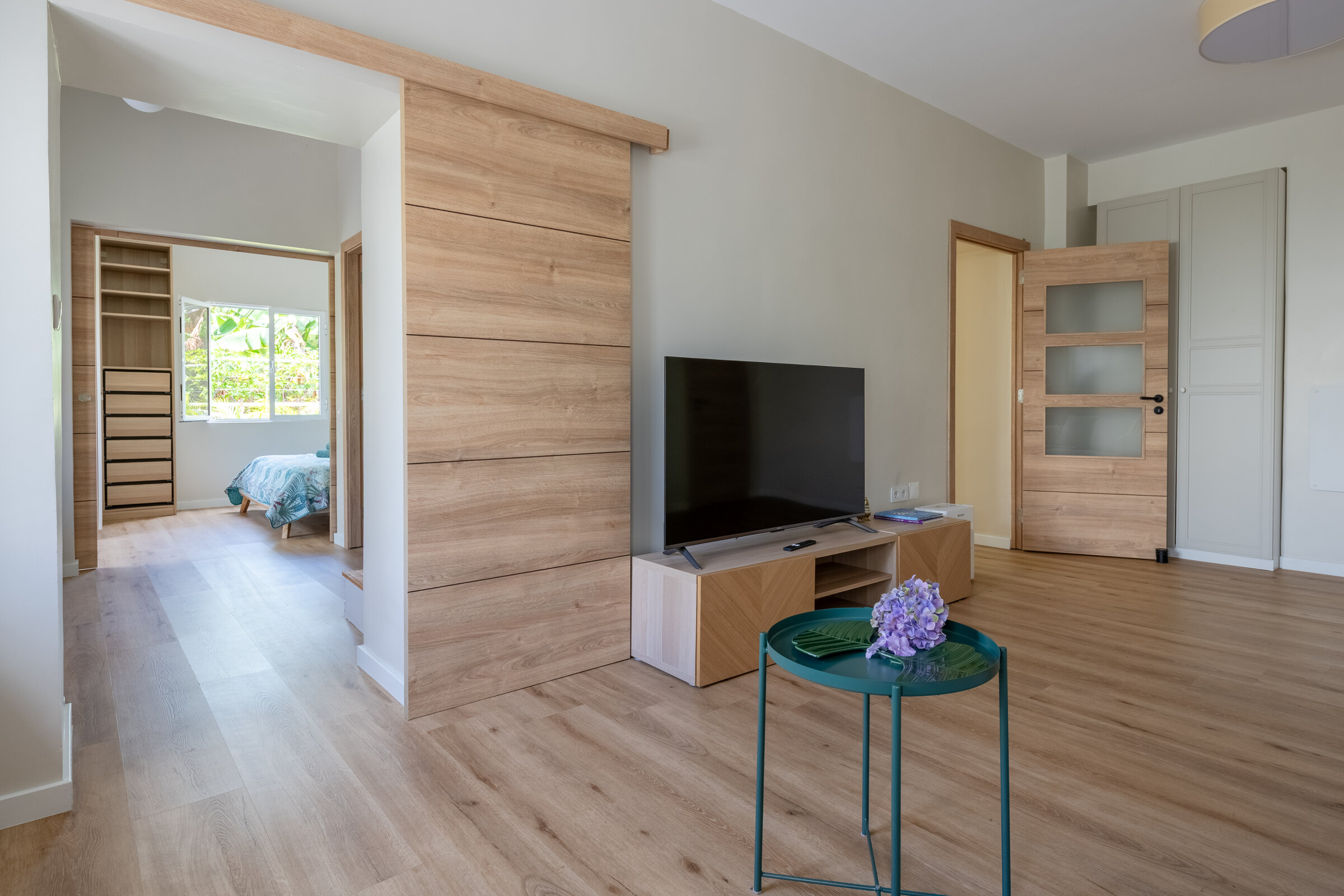 Second living room, wood-panelled wall and TV