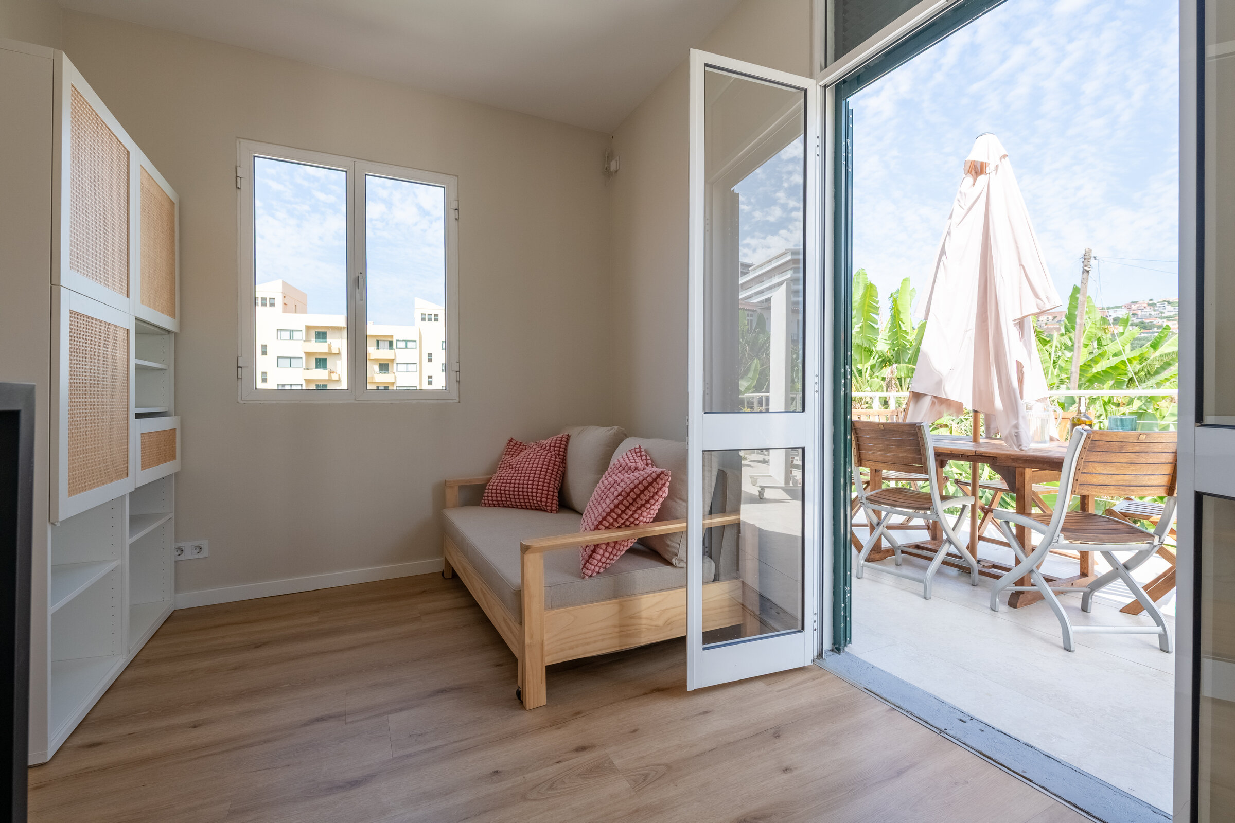 Second bedroom with daybed, doors opening onto the balcony