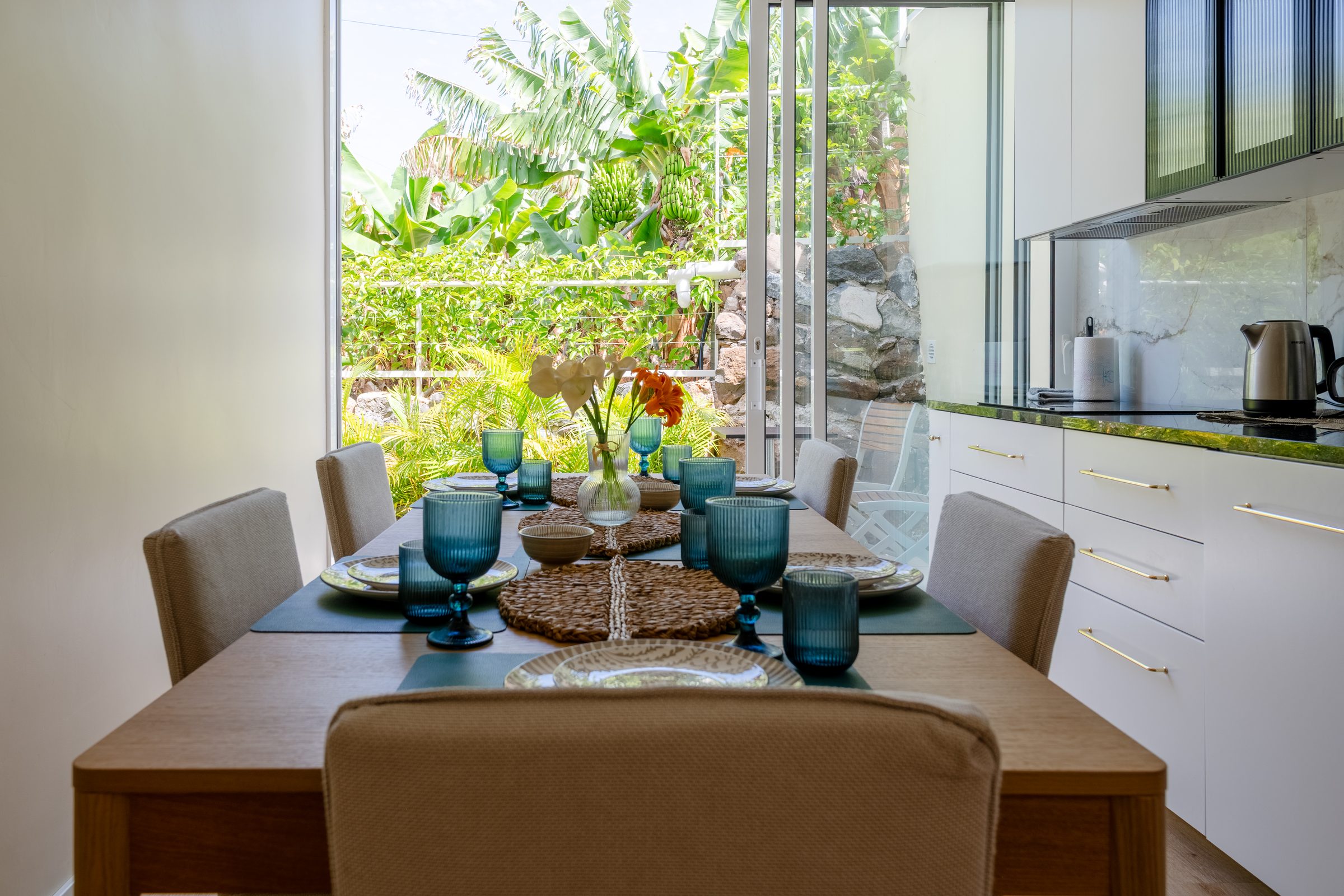 Dining table set for six, garden just beyond