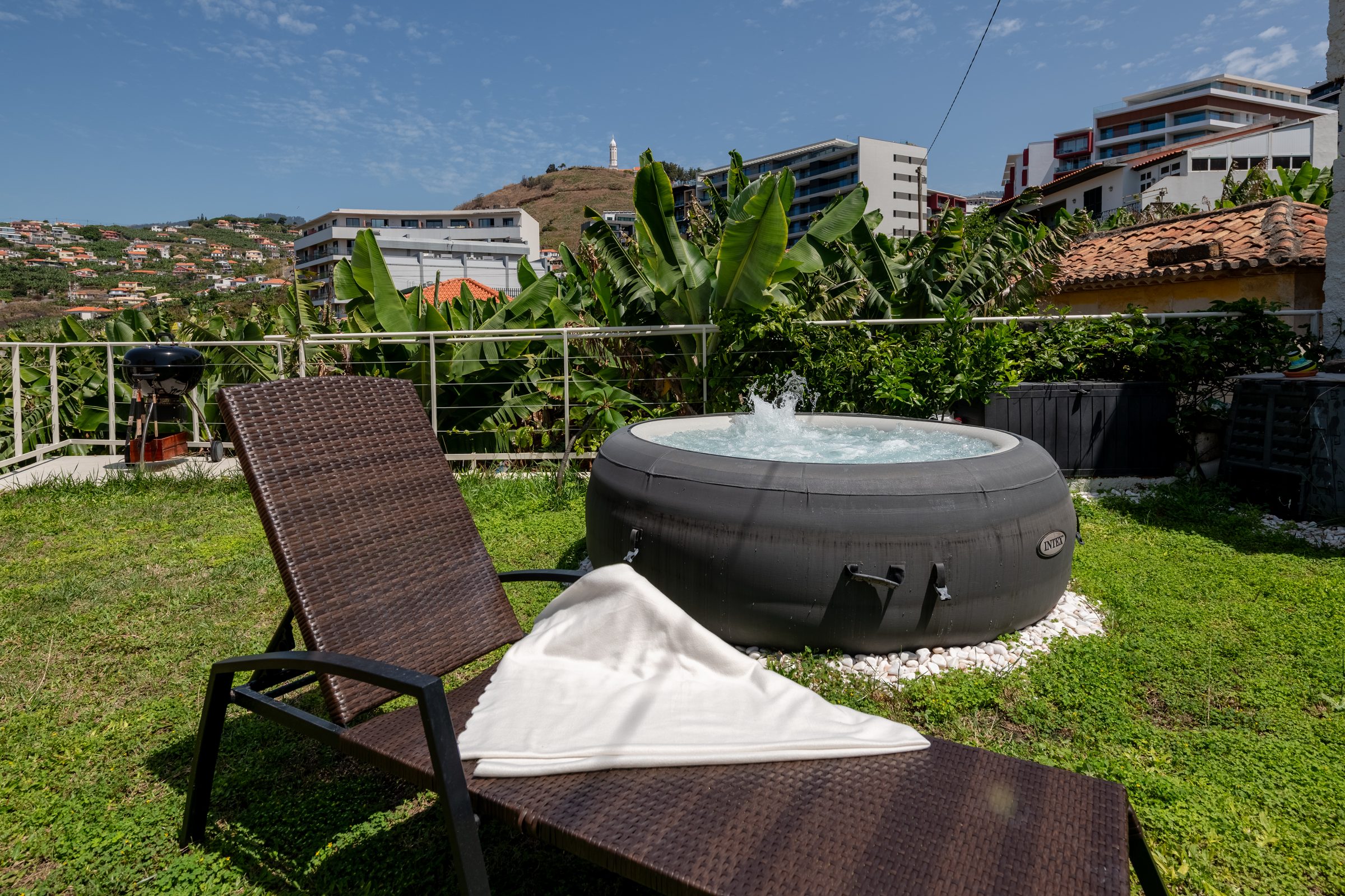 Private jacuzzi with sun lounger and city view