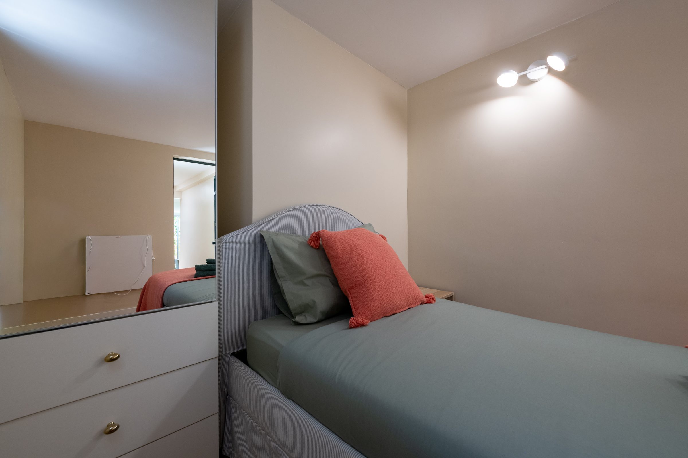 Twin bedroom with soft green linens