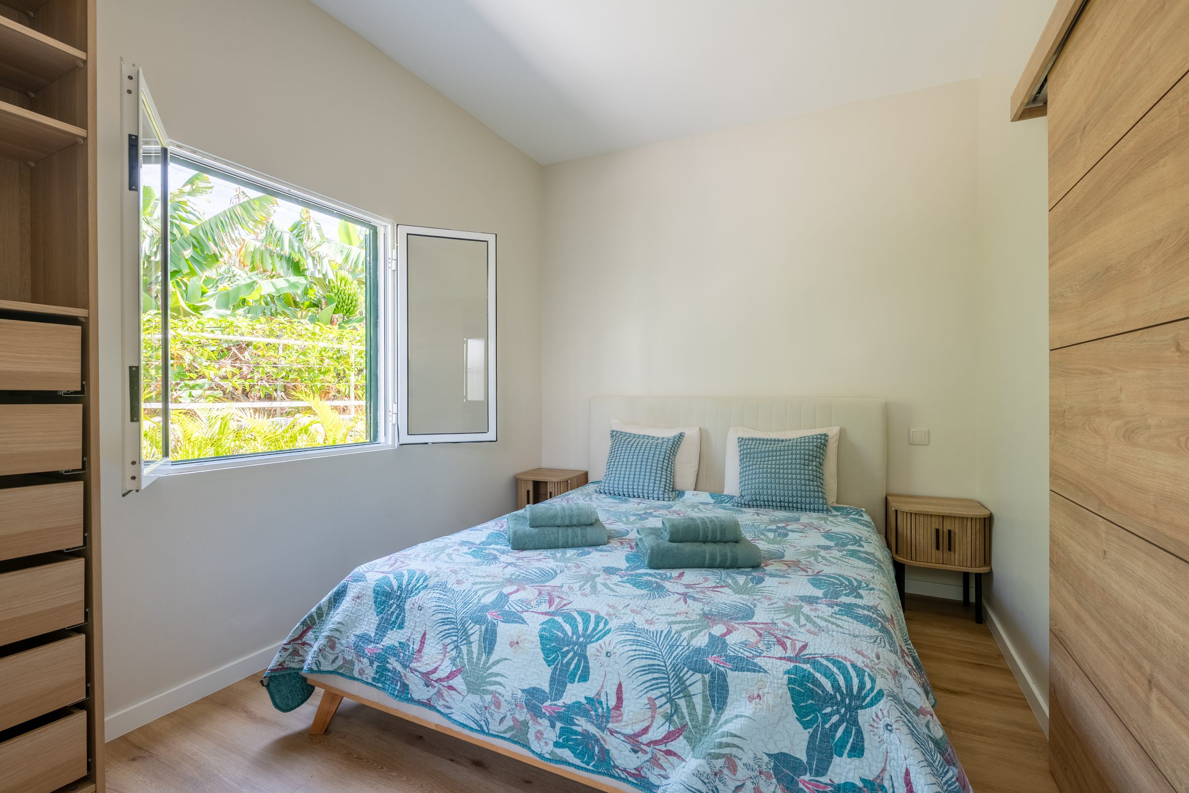 Bedroom with garden view and tropical bedspread