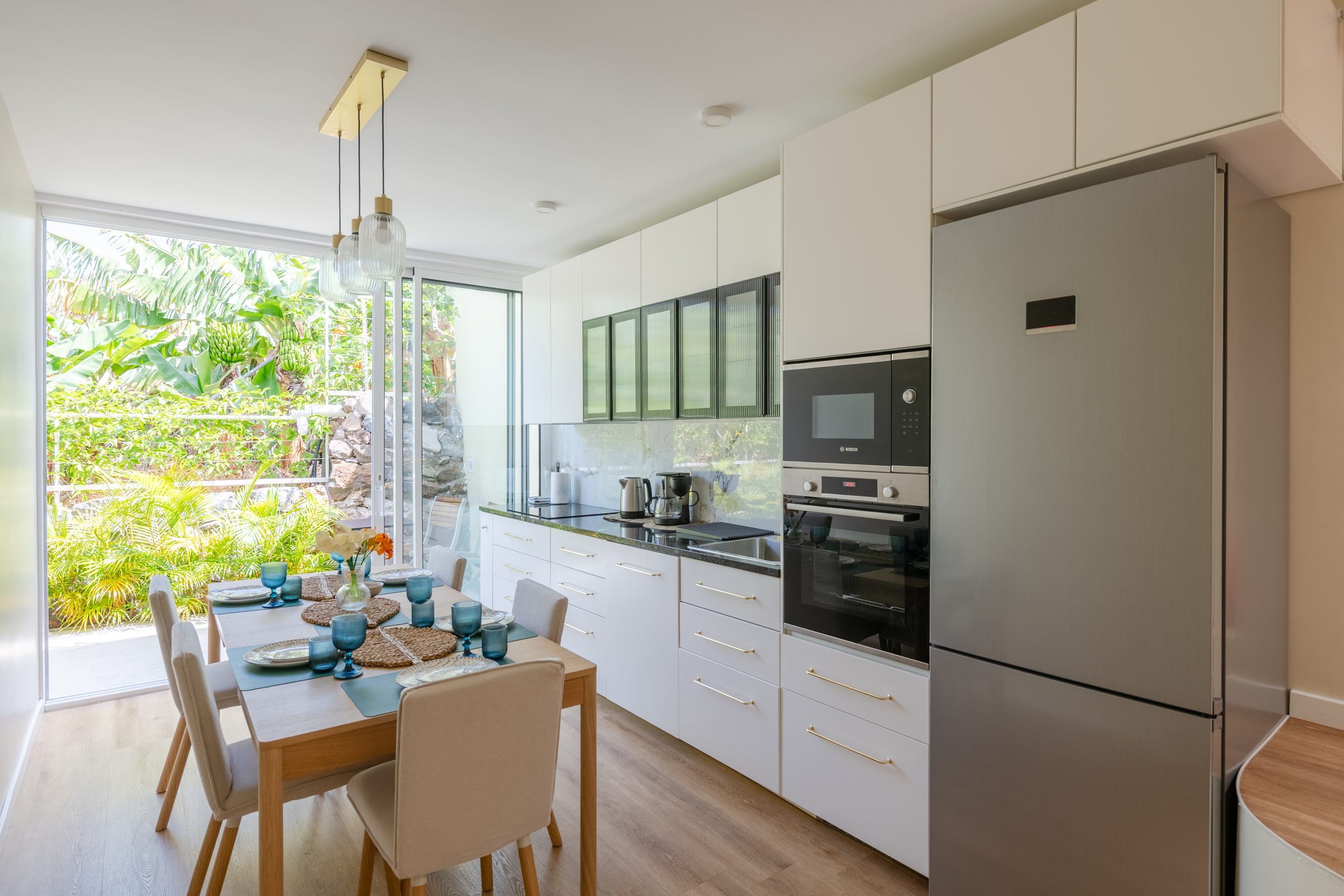 Fully equipped kitchen with dining table and garden view